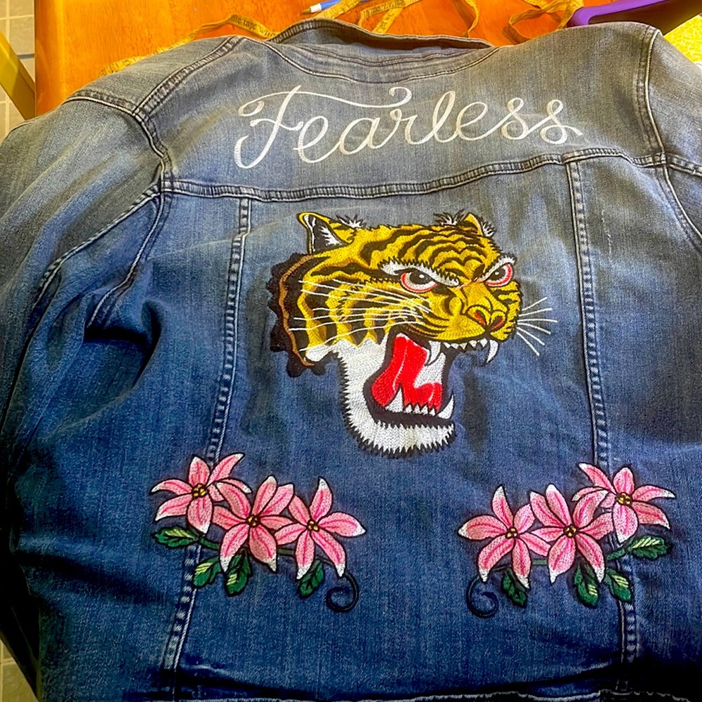 Jean jacket with flowers on the front tiger on the back middle